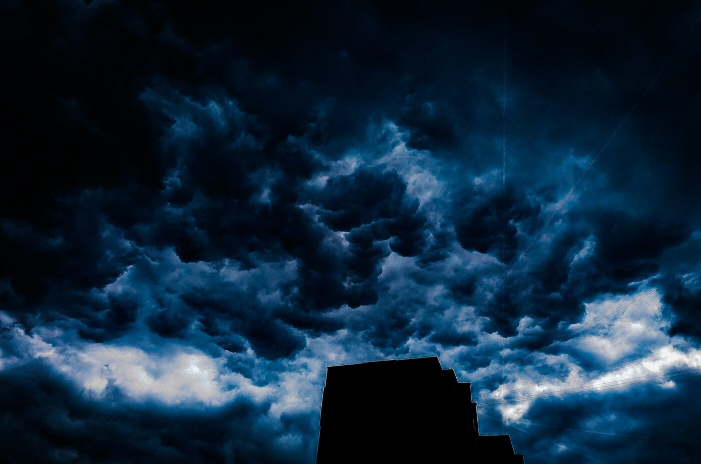 a-tall-building-sitting-under-a-cloudy-sky | © Photo by Nastia Petruk on Unsplash